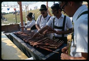 [Men Preparing Sausage on a Stick]
