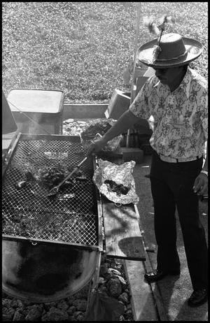 Primary view of object titled '[Man Grilling Meat]'.