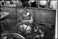 Photograph: [A Member of Austin Weavers Co-op Using a Spinning Wheel]