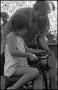 Photograph: [Girl Using Drawknife in Grandpa's Tool Shed]