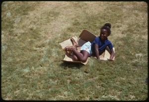Primary view of object titled '[Child Sliding Down Berm at Institute of Texas Cultures]'.