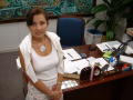 Primary view of [Elba Garcia standing in front of her desk]