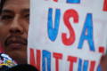Photograph: [Close-up of protester and sign]