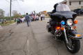Primary view of [Close-up view of policer officer on motorcycle with protesters in background]