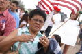 Photograph: [Female protester holding American flag]