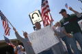 Primary view of [Group of Protesters With Signs and Flags and Blue Sky in the Background]