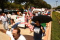 Primary view of [Protesters march with signs, banners, and U.S. flags]