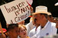 Photograph: [Protesters with sign, "Hunger is not a crime"]
