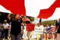 Photograph: [Protesters marching with flags and signs]