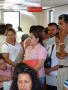 Thumbnail image of item number 1 in: '[People standing and sitting in a room under a sign that says, "Informacion"]'.
