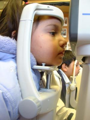 Primary view of object titled '[Two children having their eyes tested with equipment]'.