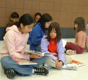 Primary view of object titled '[Students read books to each other at Seminary Hills Elementary]'.