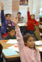 Primary view of [Students raise their hands during a class]