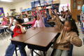 Primary view of [Students raise their hands in a Crockett Elementary class]