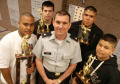 Photograph: [Instructor and students show off their awards]