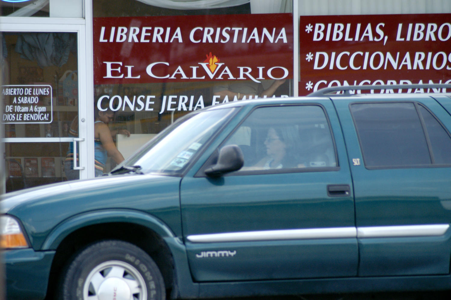 [Woman in vehicle in front of Christian bookstore with Spanish signage]
                                                
                                                    [Sequence #]: 1 of 1
                                                