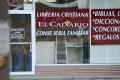 Primary view of [Glass facade of Christian bookstore with Spanish signage]