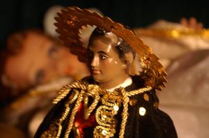 Primary view of object titled '[Figure of St. Martin de Porres with blurred image in background]'.