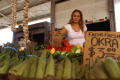 Thumbnail image of item number 1 in: '[Woman placing cardboard sign into group of vegetables]'.