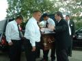 Photograph: [Men placing casket into hearse]