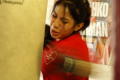 Photograph: [Young woman in red shirt hitting heavy bag]
