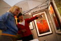 Primary view of [Woman pointing at framed artwork]