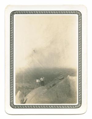 [Photograph of Two Men Standing on a Boulder]