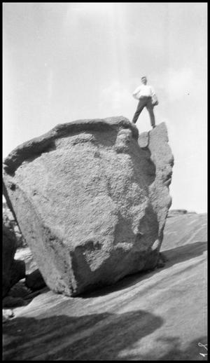 [Photograph of a Man Standing on Balanced Rock]