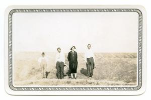 [Photograph of a Boy, two Men, and a Woman]