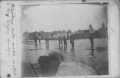 Photograph: [Photograph of Men and Boys on Floating Wooden Sidewalk]