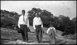 [Photograph of Two Men and a Young Boy Outside]