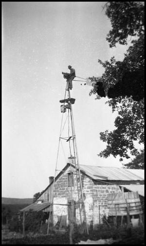 [Photograph of a Man on a Windmill]