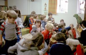 Primary view of object titled '[Children watching turtle puppet in Emily Fowler Library]'.
