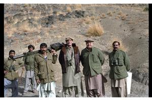 Primary view of object titled '[Charles Wilson Poses with  Mujahideen in Afghanistan]'.