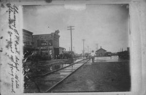 Primary view of object titled '[Photograph of Railroad Street next to Southern Pacific Passenger Depot During Flood]'.