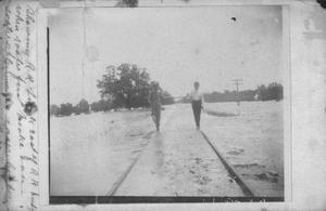 Primary view of object titled '[Photograph of Men Walking on Flooded Railroad Track]'.