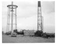 Photograph: [Water tower construction with drill rig]