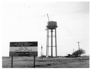 [Water tower construction with site sign]