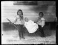 Photograph: [two children, baby in wagon]