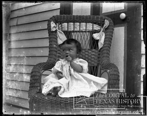 Primary view of object titled '[child in wicker chair #1]'.