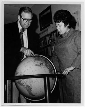 [Man and Woman Examining a Globe]