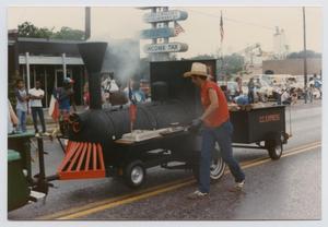 Primary view of object titled '[Barbecue Trailer in a League City Parade]'.
