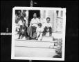 Primary view of [A Woman and Children Sitting on Front Steps]