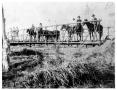 Photograph: Men on Horseback on a Bridge