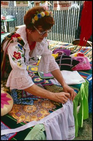 [Woman Displaying Polish Costumes and Needlework]