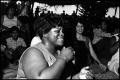 Photograph: [Woman Singing in Audience at Gospel Stage]