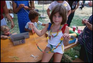 [Girl Making Pasta Necklace]