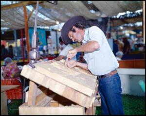 [Man Working on Woodcarving]