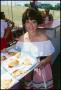 Photograph: [Woman Holding a Tray of Pizza Slices]