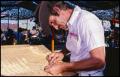 Primary view of [Charles Davis Making a Woodcarving]